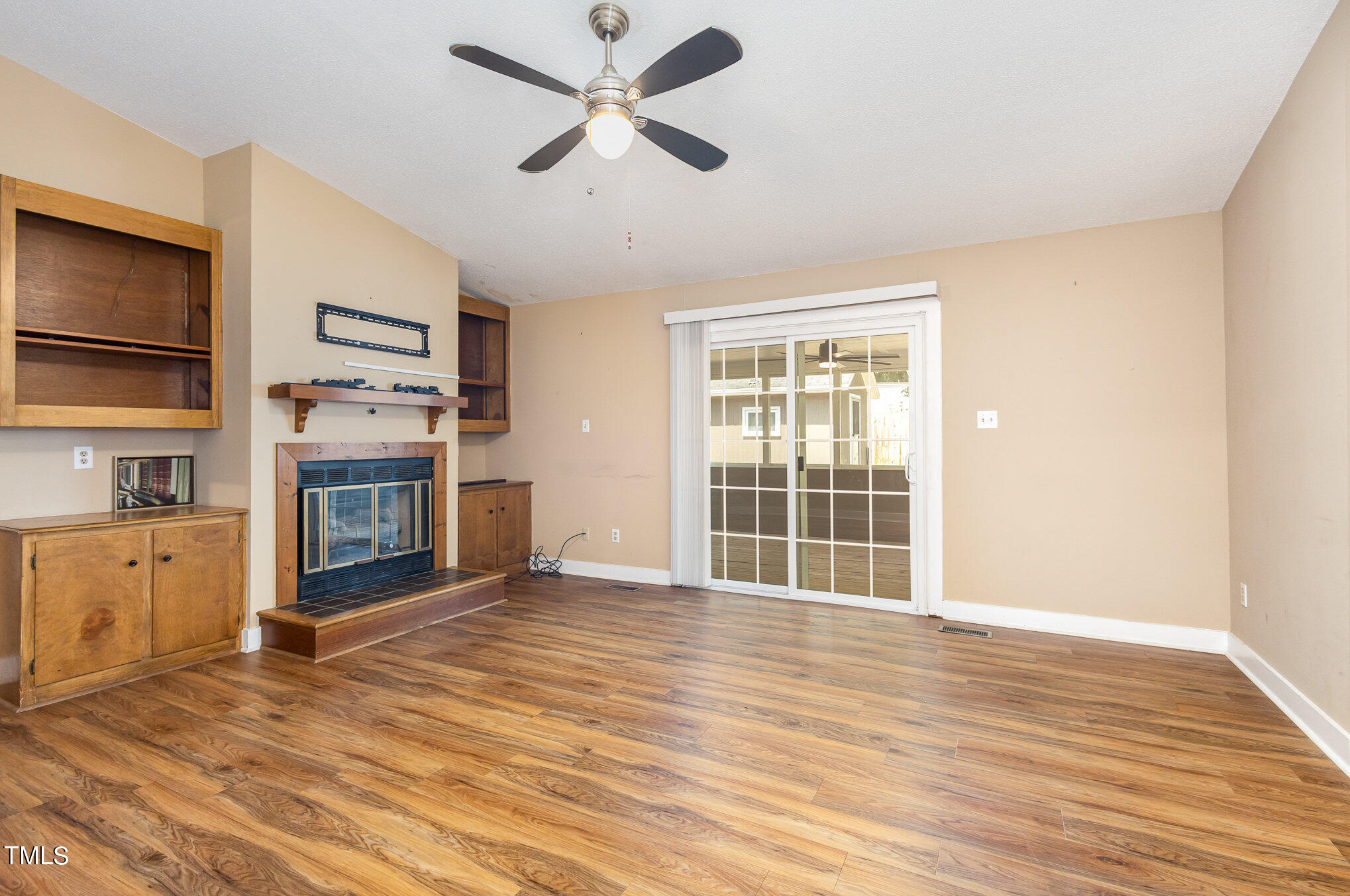 814 Wyldewood Road Durham, NC 27704 - Photo 6 of 26 a view of empty room with wooden floor and fan