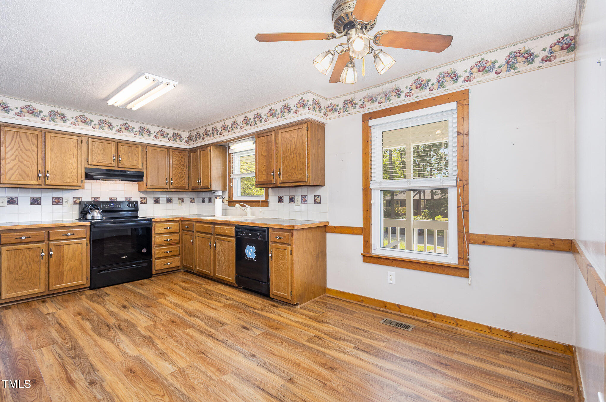 814 Wyldewood Road Durham, NC 27704 - Photo 8 of 26 a kitchen with stainless steel appliances kitchen island granite countertop a stove a sink and a microwave