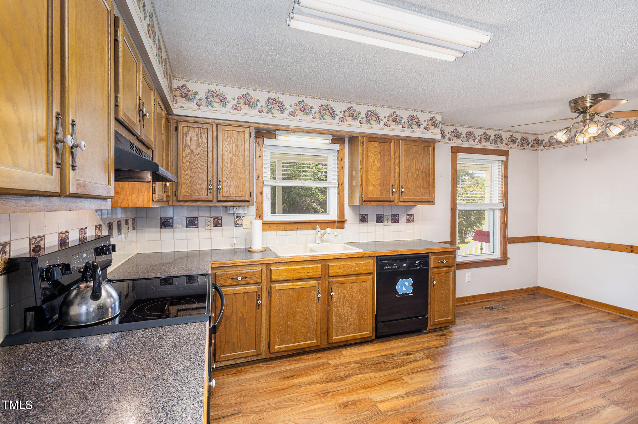 814 Wyldewood Road Durham, NC 27704 - Photo 10 of 26 a kitchen with stainless steel appliances granite countertop a sink and cabinets