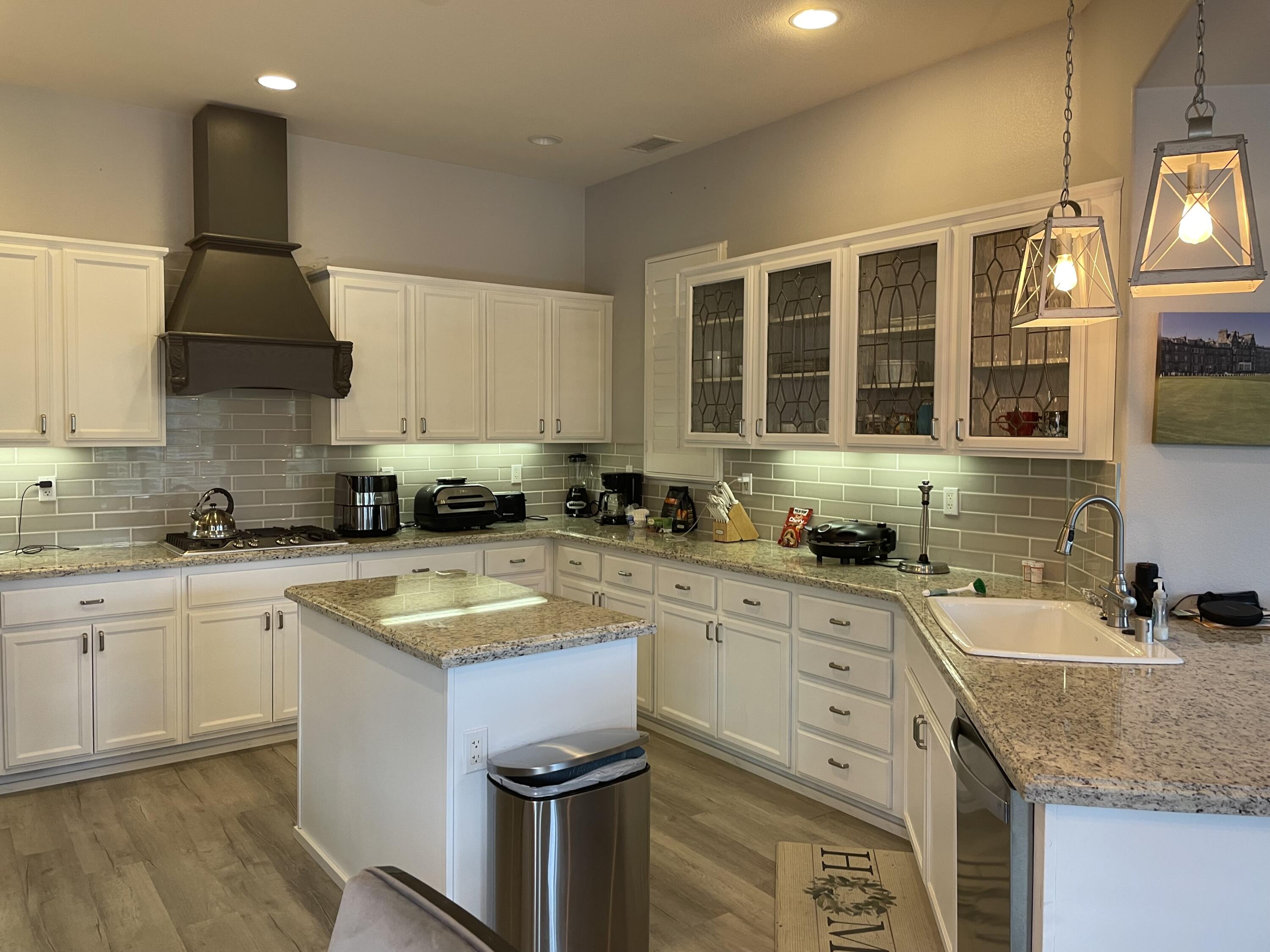 a kitchen with a sink stove and microwave