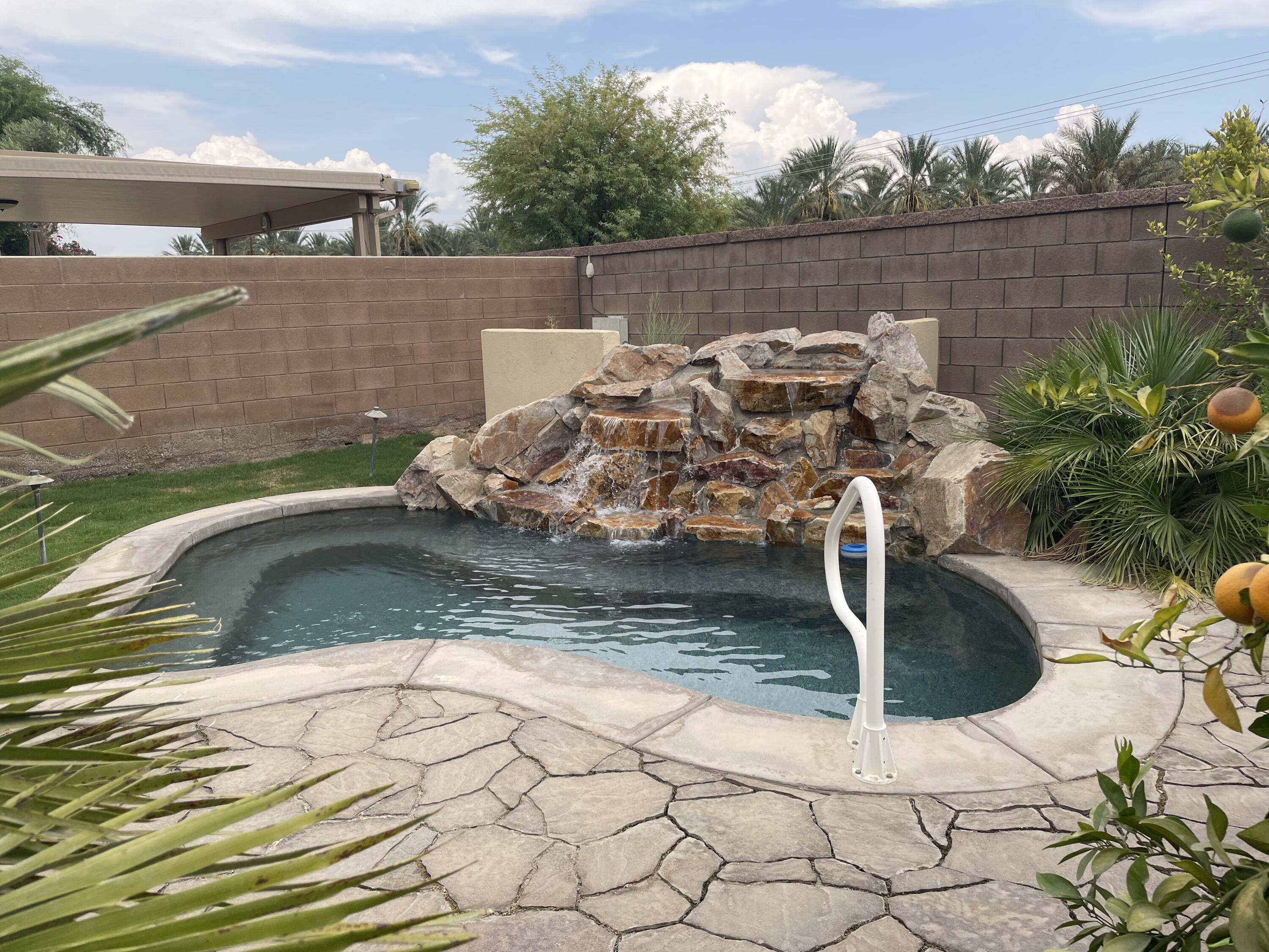 61232 Cactus Spring Drive La Quinta, CA 92253 - Photo 12 of 30 a view of a backyard with plants and lake view