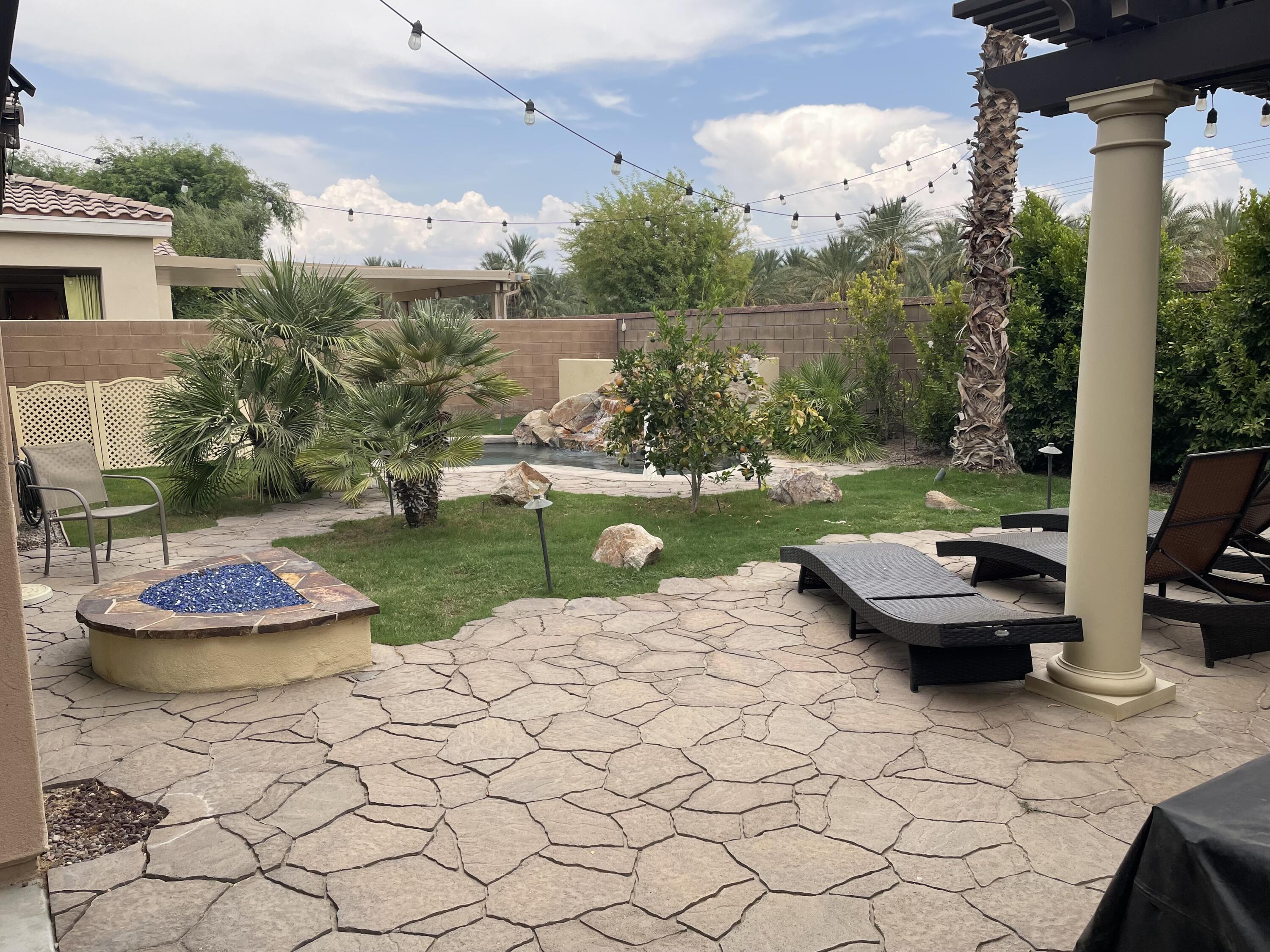 61232 Cactus Spring Drive La Quinta, CA 92253 - Photo 13 of 30 a view of a backyard with sitting area