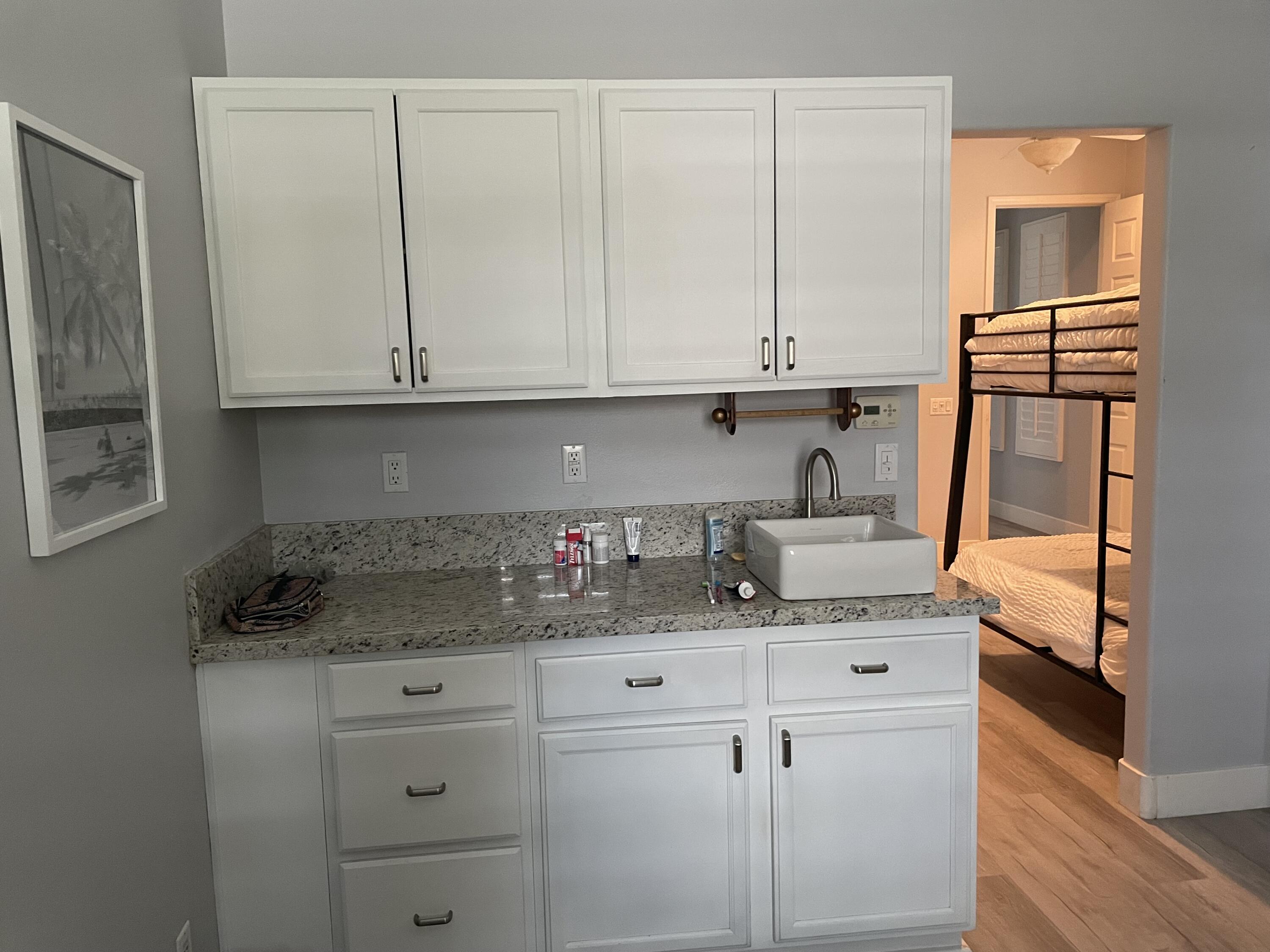61232 Cactus Spring Drive La Quinta, CA 92253 - Photo 25 of 30 a kitchen with granite countertop a sink and cabinets