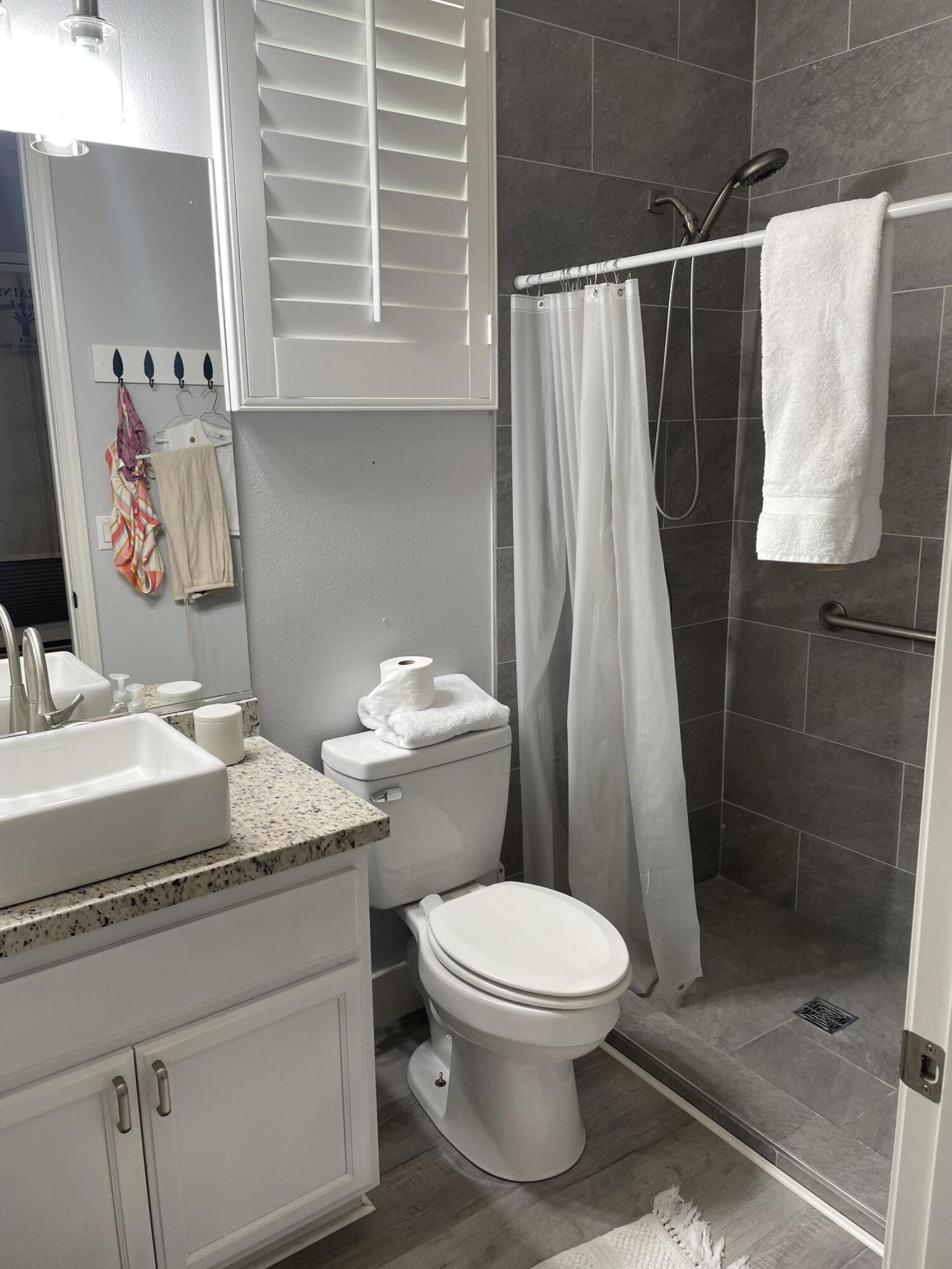 61232 Cactus Spring Drive La Quinta, CA 92253 - Photo 28 of 30 a bathroom with a granite countertop sink toilet and shower