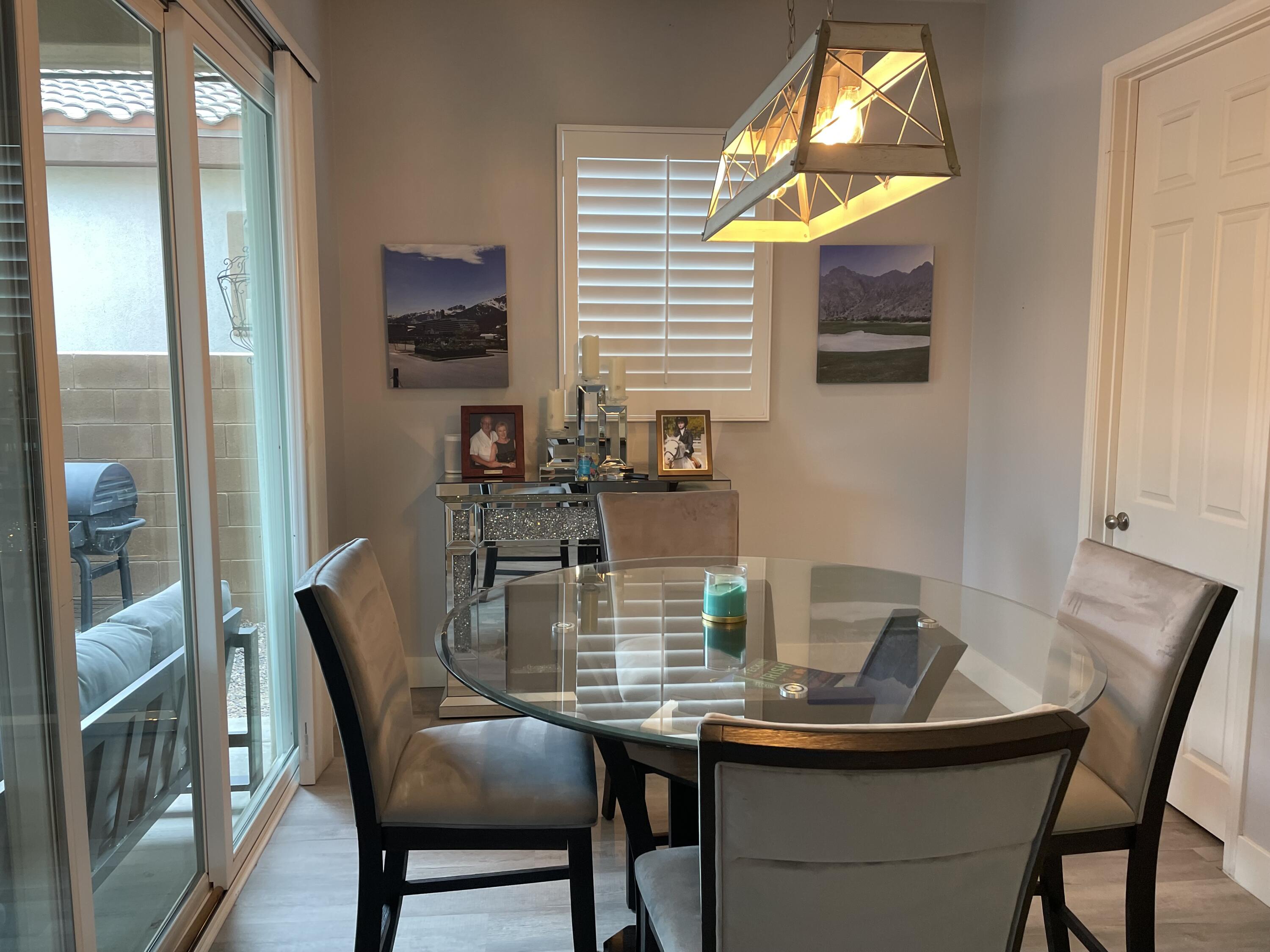 61232 Cactus Spring Drive La Quinta, CA 92253 - Photo 3 of 30 a view of a dining room with furniture and a window