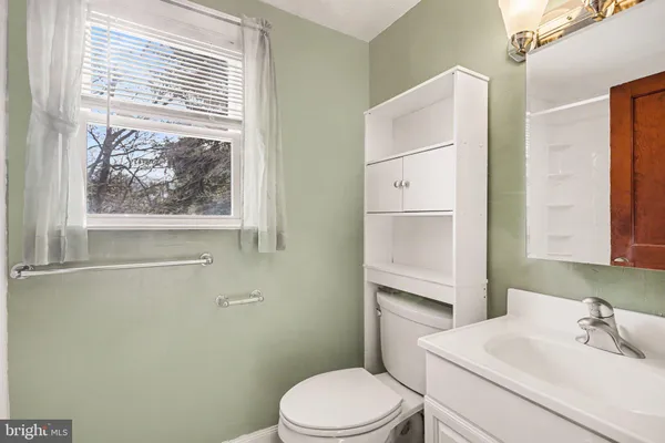 a white toilet sitting next to a bathroom sink
