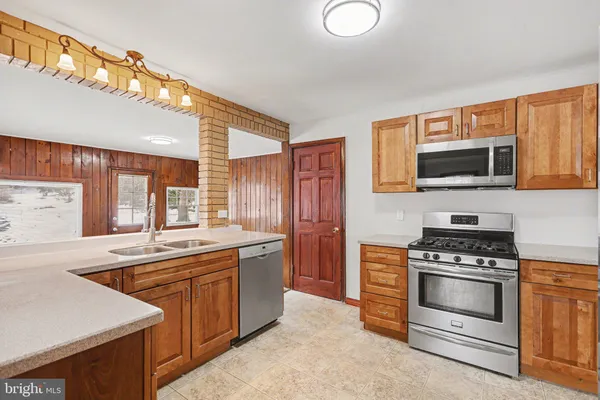a kitchen with a sink stove and microwave