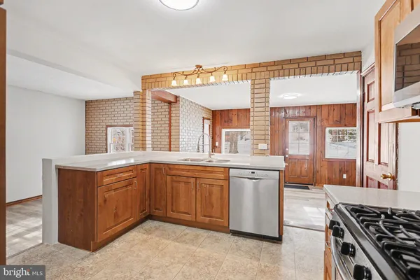 a kitchen with stainless steel appliances granite countertop a stove a sink dishwasher and cabinets