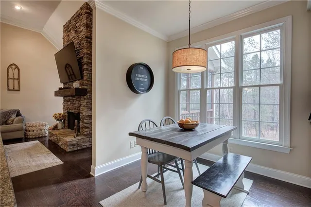 a dining room with wooden floor and a window