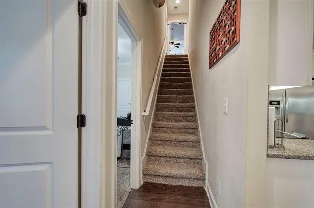 a view of a hallway with wooden floor and entryway