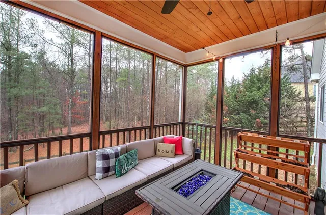 a balcony with furniture and wooden floor
