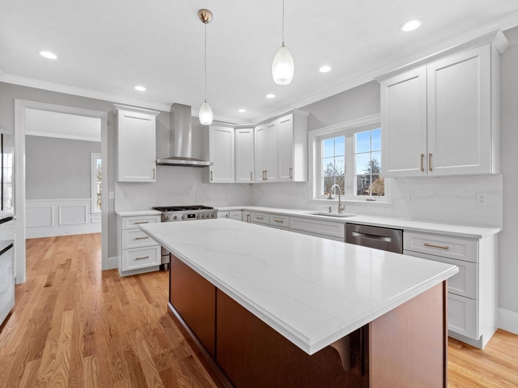 46 Lackey Street Westborough, MA 01581 - Photo 15 of 42 a large kitchen with kitchen island a stove a sink a center island and wooden floor