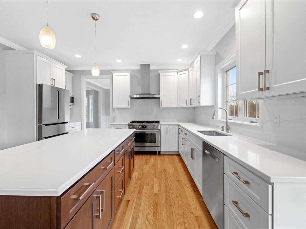 46 Lackey Street Westborough, MA 01581 - Photo 16 of 42 a large kitchen with stainless steel appliances lots of counter space and wooden floor