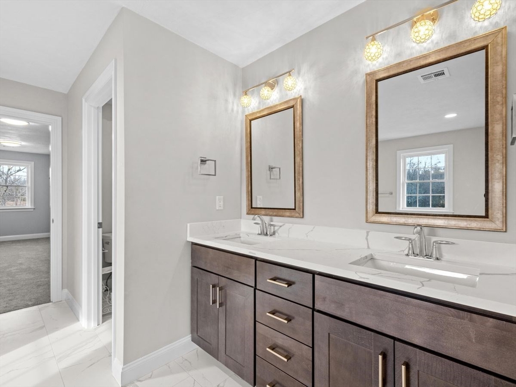 46 Lackey Street Westborough, MA 01581 - Photo 27 of 42 a bathroom with double vanity sinks and a mirror