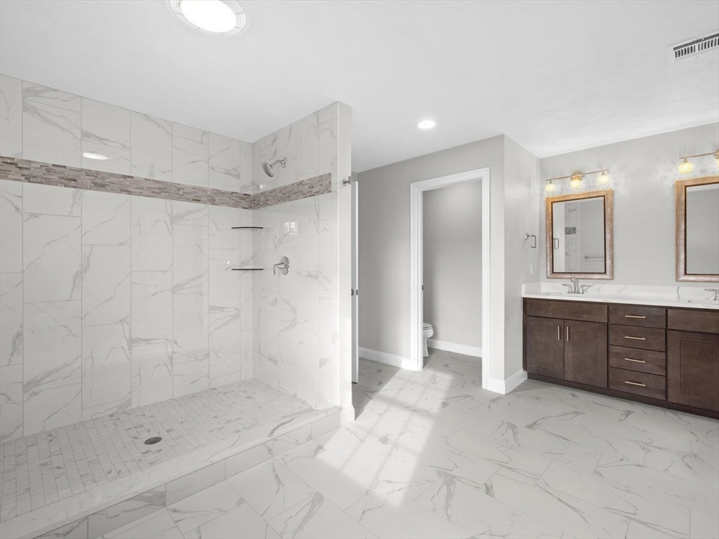 46 Lackey Street Westborough, MA 01581 - Photo 29 of 42 a bathroom with a shower a sink and a mirror