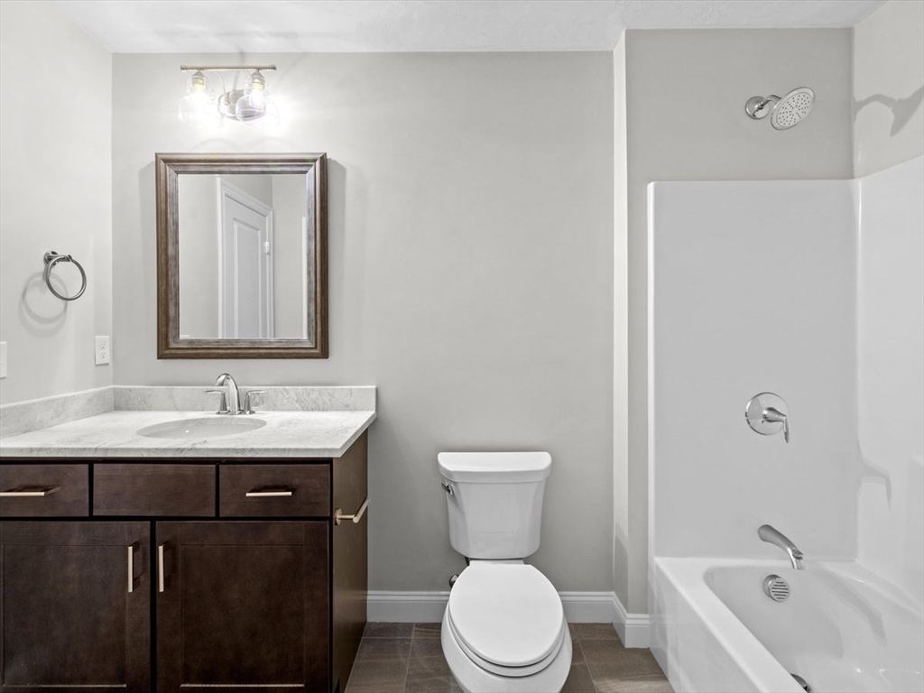 46 Lackey Street Westborough, MA 01581 - Photo 34 of 42 a bathroom with a toilet a sink and a bathtub