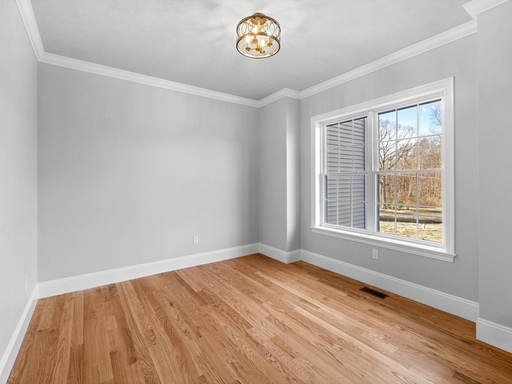 46 Lackey Street Westborough, MA 01581 - Photo 6 of 42 an empty room with a window and wooden floor