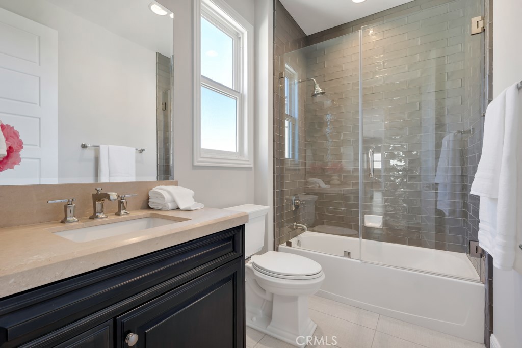 20120 Jubilee Way Porter Ranch, CA 91326 - Photo 42 of 55 a bathroom with a granite countertop sink a toilet and shower