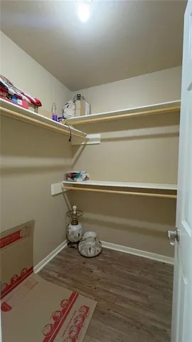 a view of table with racks on the wall