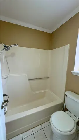 a bathroom with a toilet and bathtub