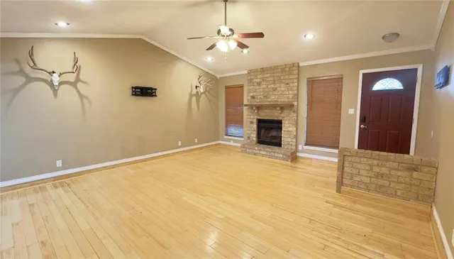 a view of an empty room with a fireplace
