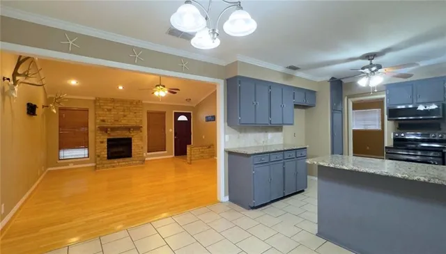 a large kitchen with kitchen island a sink stainless steel appliances and cabinets