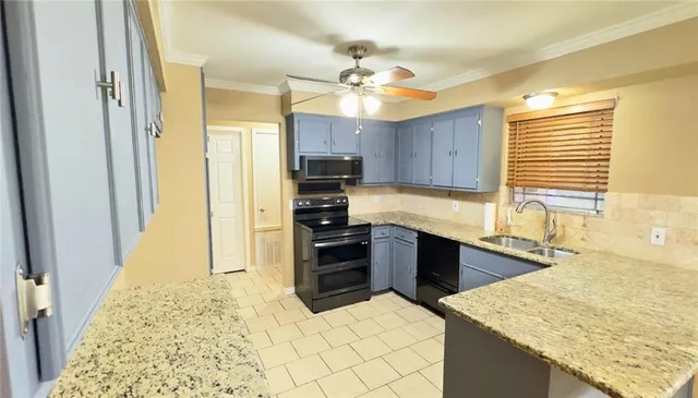 a kitchen with stainless steel appliances kitchen island granite countertop a refrigerator stove and sink