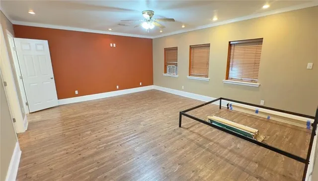 a view of room with window and wooden floor
