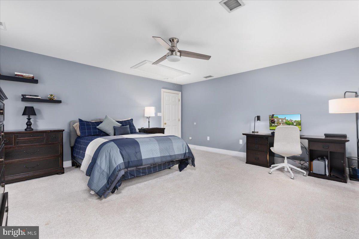 14915 Alpine Bay Loop Gainesville, VA 20155 - Photo 44 of 105 a bedroom with a bed and a chandelier