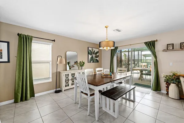 a dining room with furniture and window