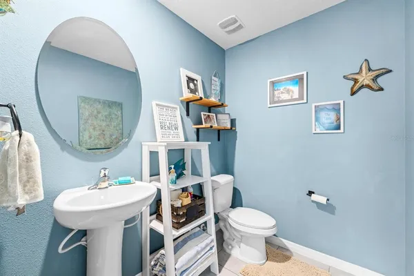 a bathroom with a toilet a sink and a mirror