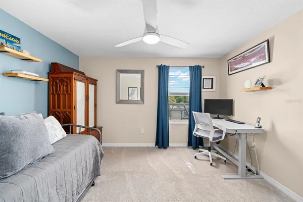 a bedroom with a workspace