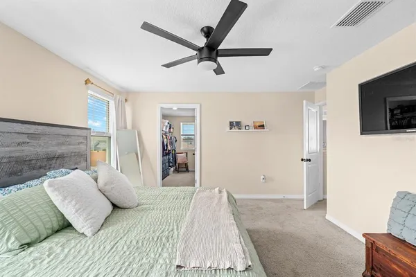a bedroom with a bed and a chandelier