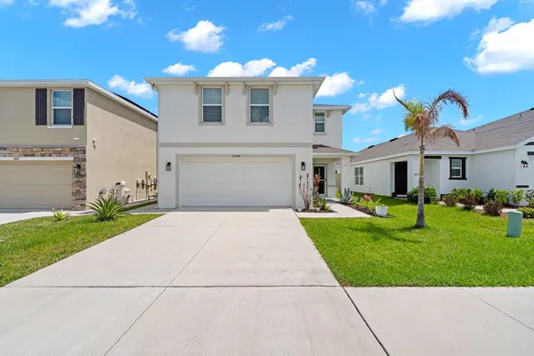 a front view of a house with a yard and garage