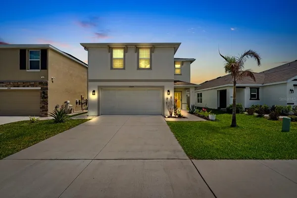 a front view of a house with a yard and garage