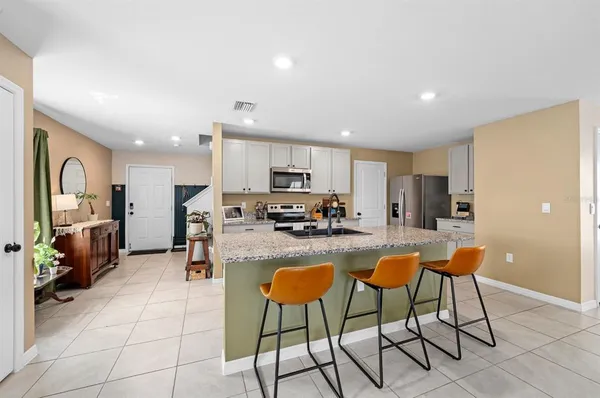 a kitchen with stainless steel appliances granite countertop a refrigerator and microwave