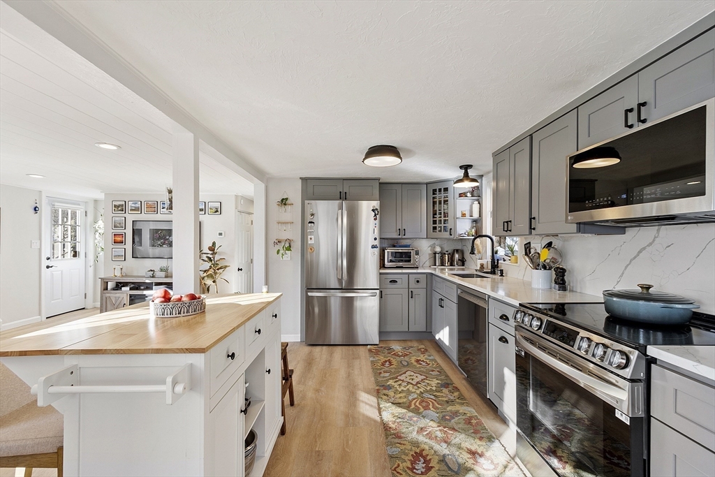 8 Bacon Street Oxford, MA 01540 - Photo 6 of 38 a kitchen with a sink stainless steel appliances and cabinets