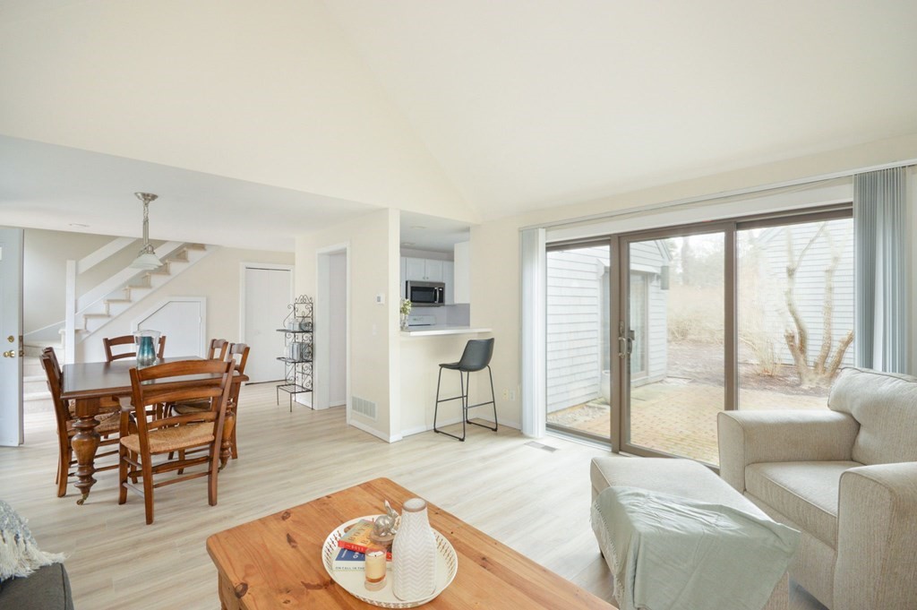 68 Mid-Iron Way, Unit 7544 Mashpee, MA 02649 - Photo 1 of 21 a living room with furniture and a large window