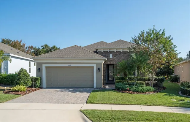 a front view of a house with a yard and garage