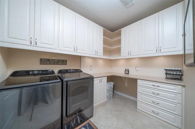 a kitchen with white cabinets and appliances