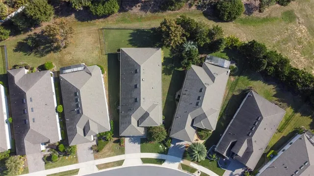 an aerial view of a house with outdoor space