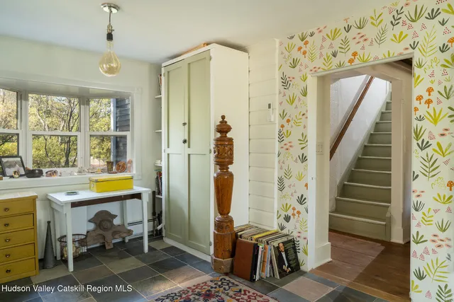 a view of a hallway with workspace and windows