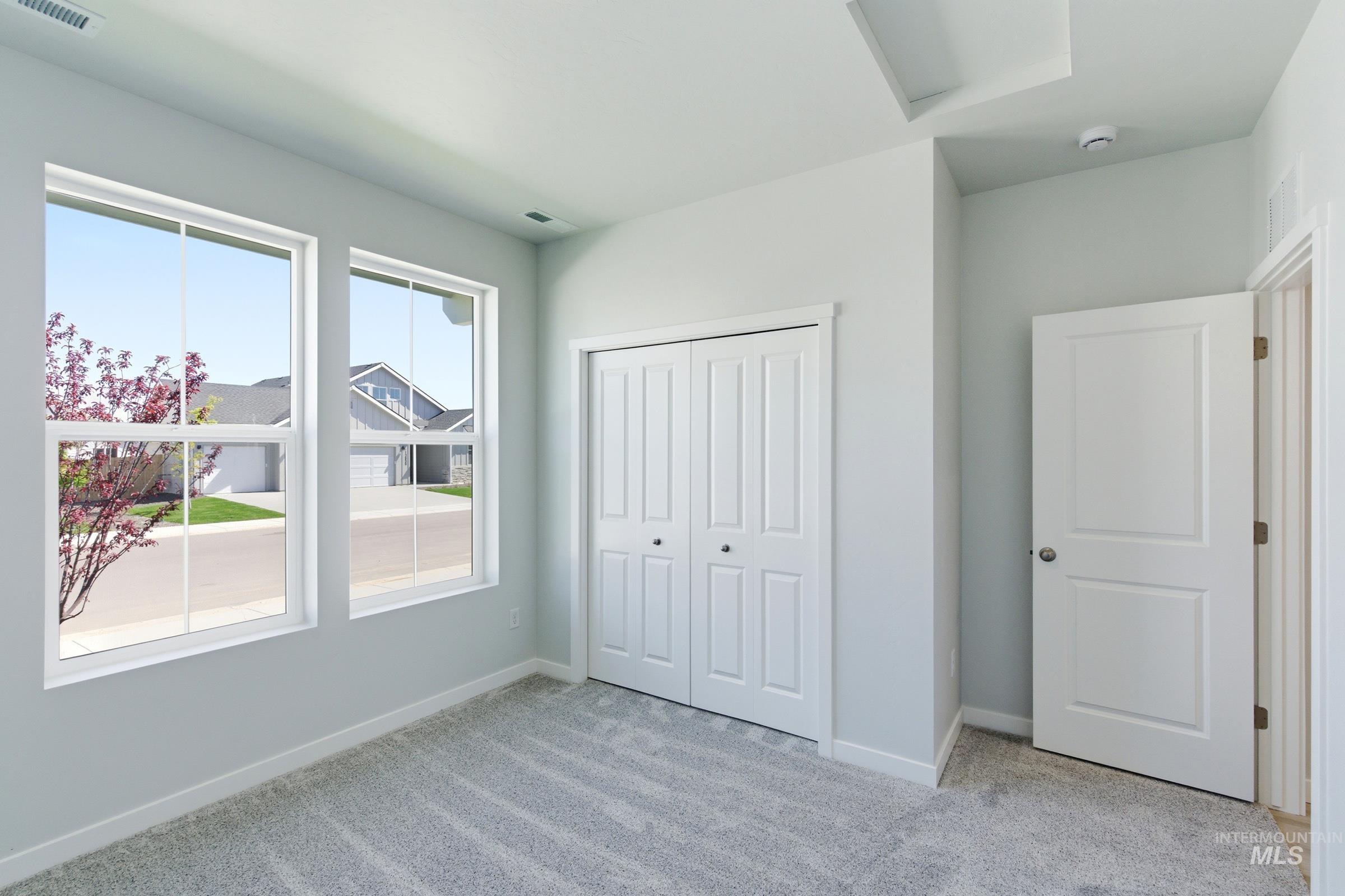 13663 Redway Court Caldwell, ID 83607 - Photo 19 of 32 Light gray carpeted room featuring two white-framed windows