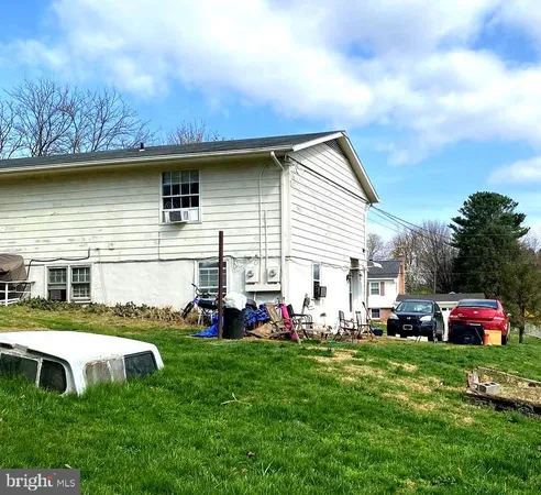 a front view of a house with a yard and trees