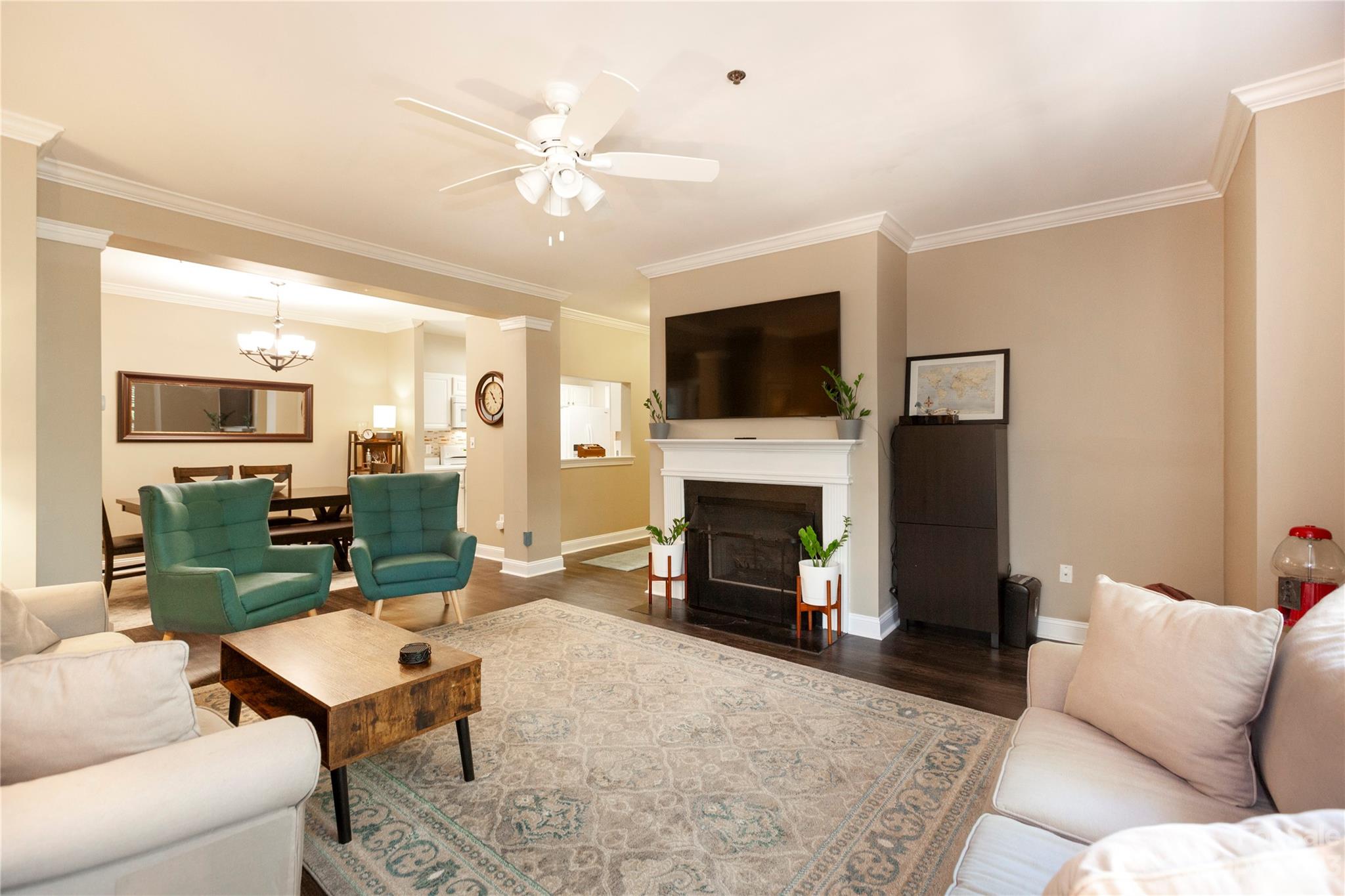 a living room with furniture a fireplace and a flat screen tv