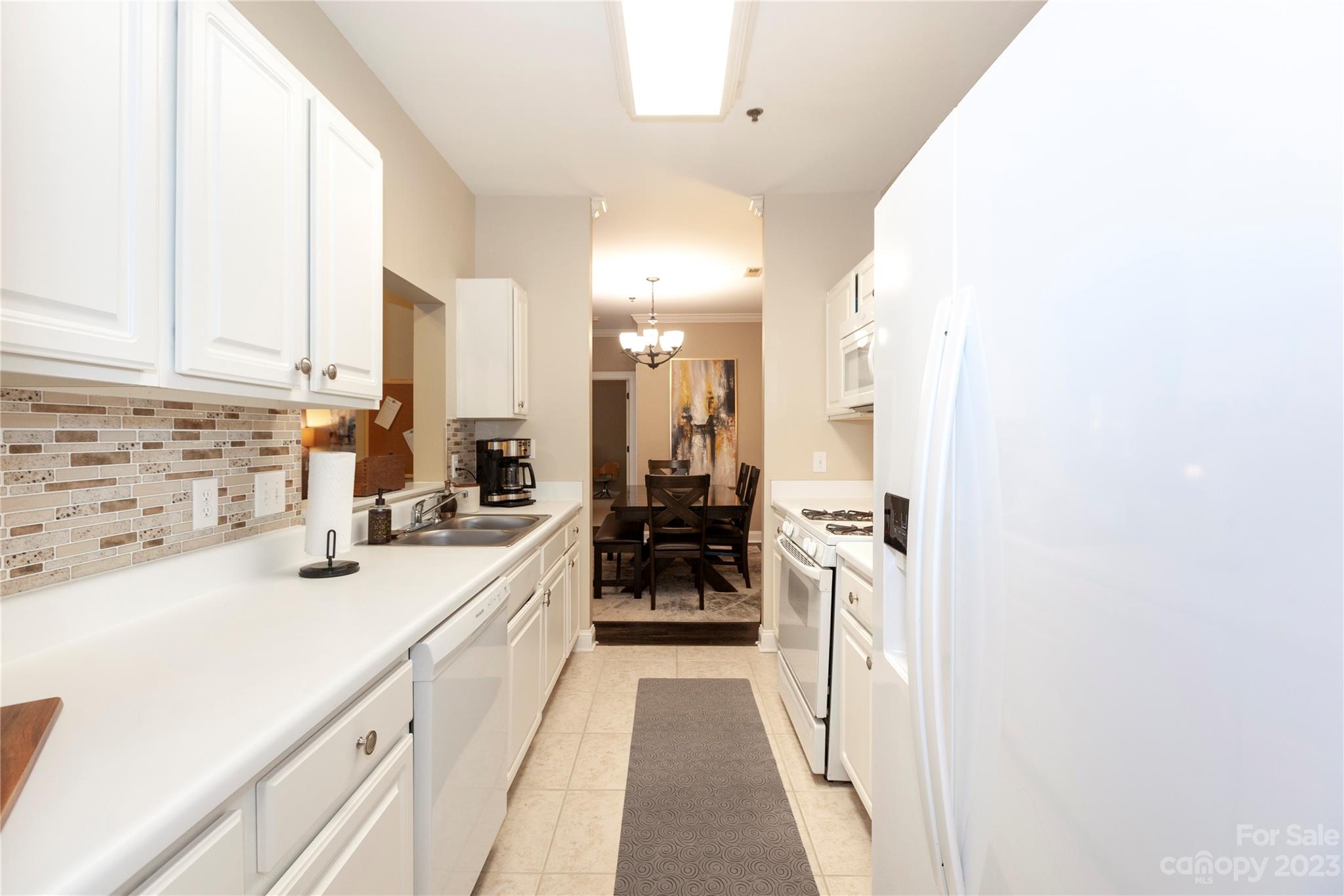 5601 Fairview Road, Unit 19 Charlotte, NC 28209 - Photo 11 of 30 a kitchen with a sink and refrigerator