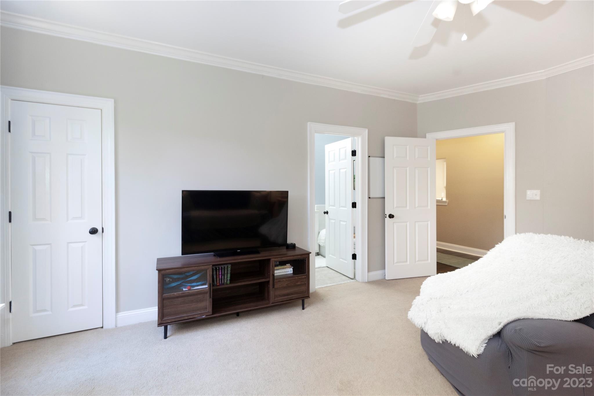 5601 Fairview Road, Unit 19 Charlotte, NC 28209 - Photo 15 of 30 a bedroom with furniture and flat screen tv