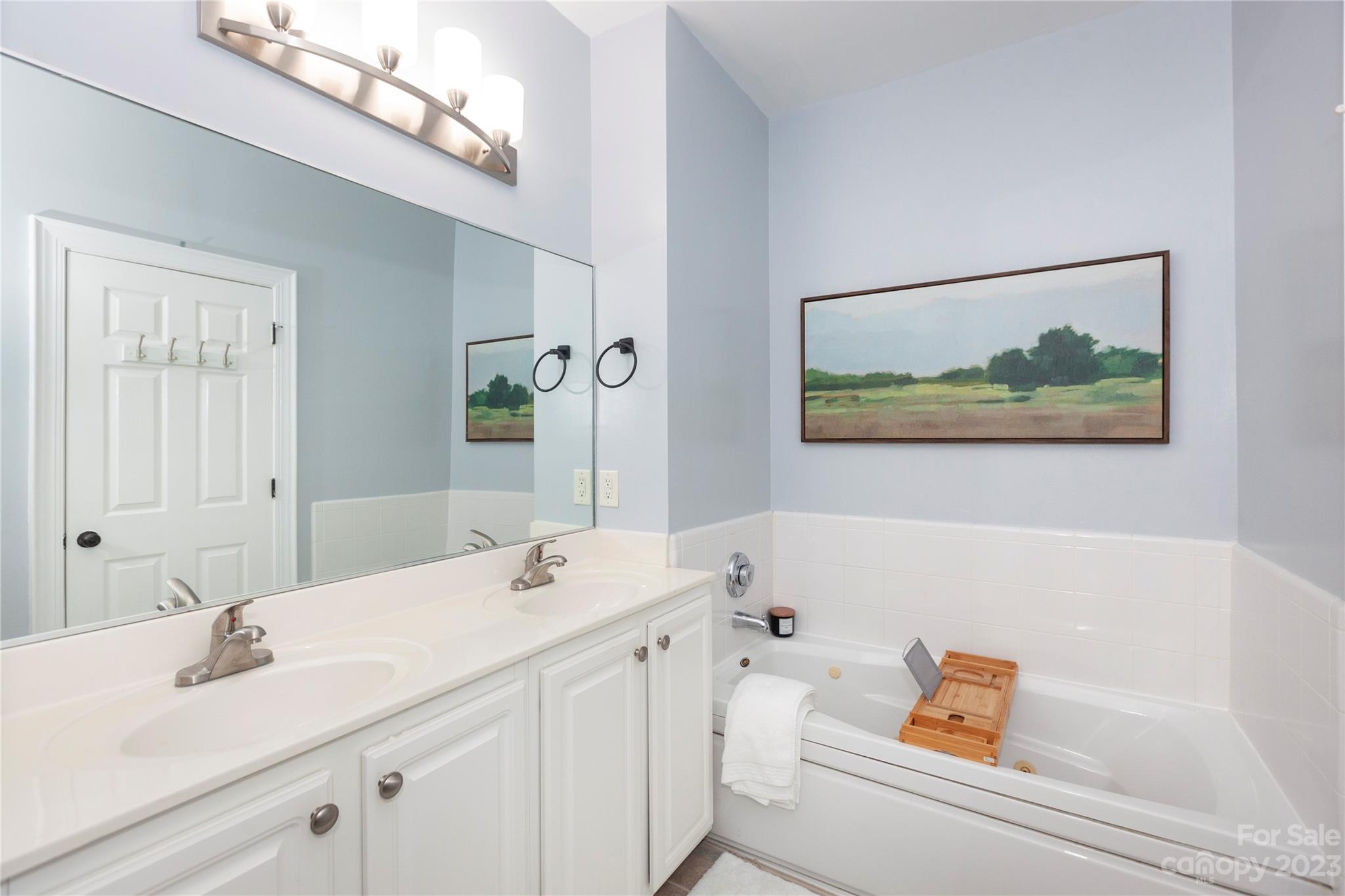 5601 Fairview Road, Unit 19 Charlotte, NC 28209 - Photo 16 of 30 a bathroom with a tub sink and mirror