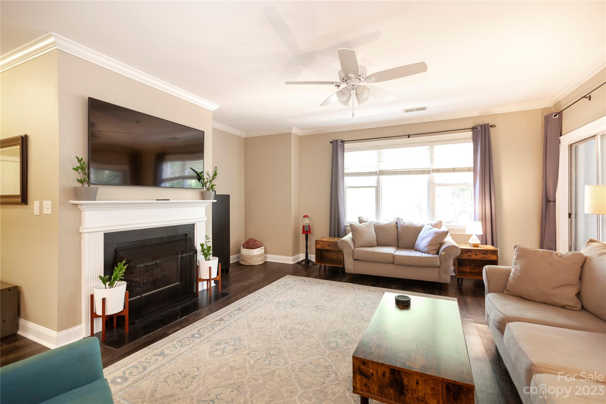 5601 Fairview Road, Unit 19 Charlotte, NC 28209 - Photo 2 of 30 a living room with furniture a flat screen tv and a fireplace