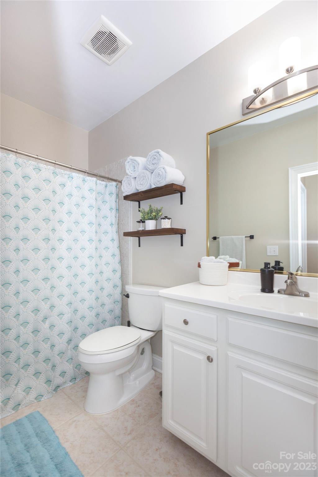 5601 Fairview Road, Unit 19 Charlotte, NC 28209 - Photo 25 of 30 a bathroom with a granite countertop toilet sink and mirror